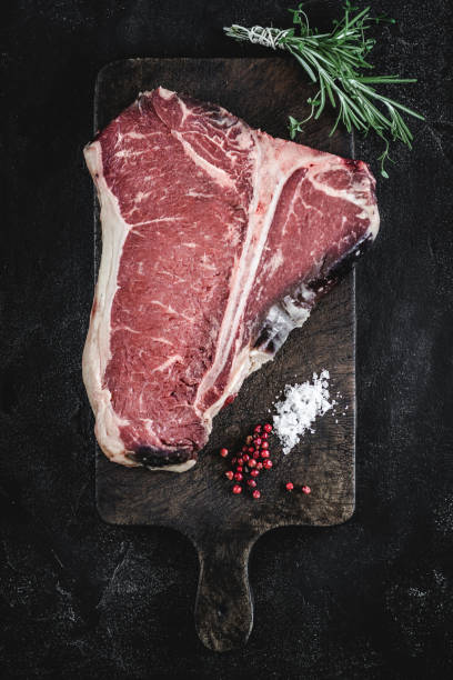 istock Dry Aged Beef Raw T-bone Steak on Vintage Cutting Board 1160530217