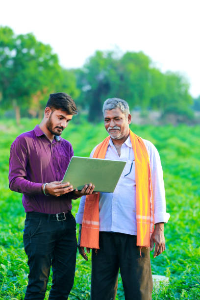 istock indian agronomist with farmer at field 1160530306