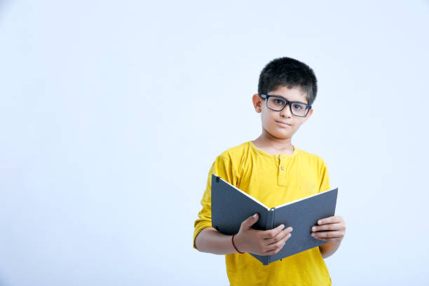 istock young indian cute child with book 1160530424