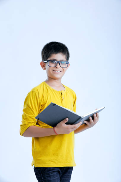 istock young indian cute child with book 1160531232