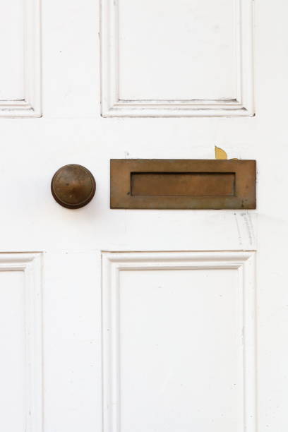 Venetian wooden door painted in brown color with mail slot and handle