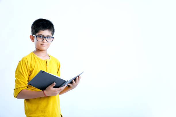 istock young indian cute child with book 1160532125