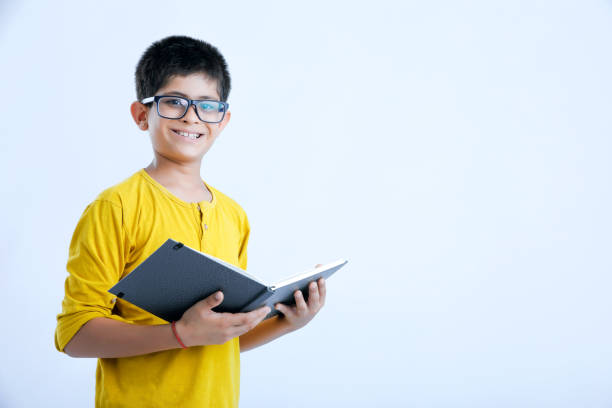 istock young indian cute child with book 1160532127