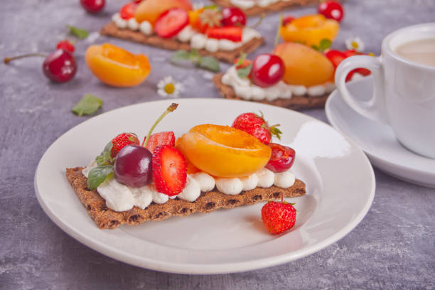 istock Crisp bread with creme cheese, fruit and berries 1160532200