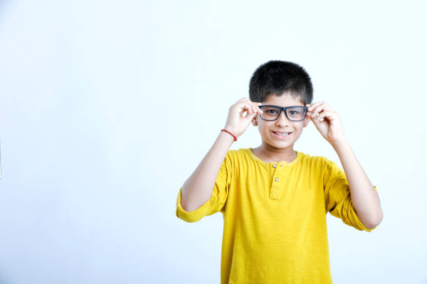 young cute indian child standing over white background