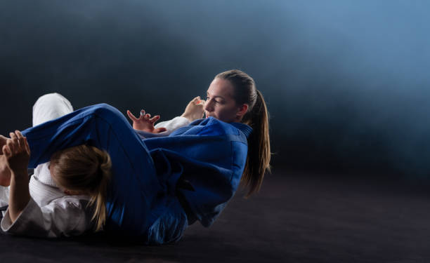 Female Judoka Choking Her Sparring Partner With Her Legs