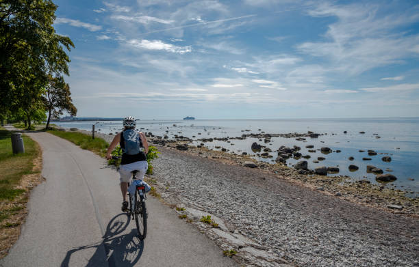 Woman bicycling on the country road