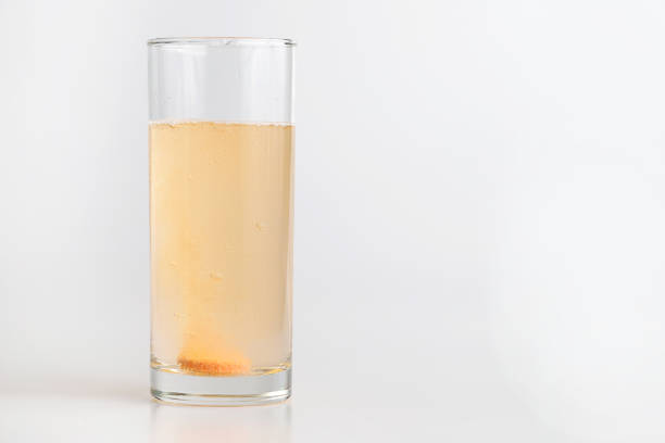 Dissolving effervescent tablet in a glass of drinking water stock photo