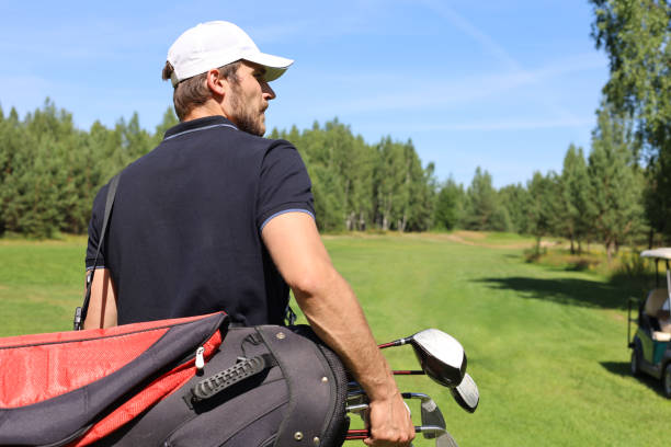 istock Golf player walking and carrying bag on course during summer game golfing. 1160536161