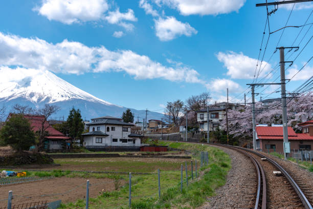 istock Fujikyu Railway train railroad track with snow covered Mount Fuji 1160536192