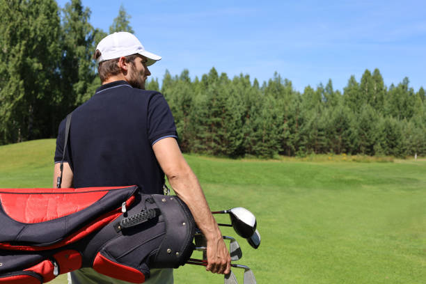 istock Golf player walking and carrying bag on course during summer game golfing. 1160536915