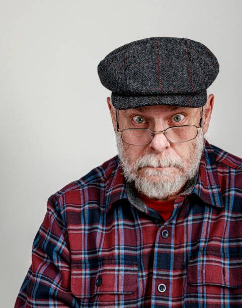 istock Surprised Senior Man Wearing Tweed Wool Flat Cap 1160537143