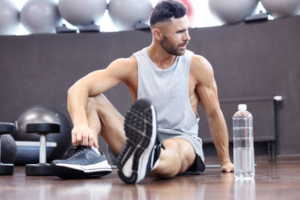 istock Sporty man resting, having break drinking water after doing exercise. 1160537158