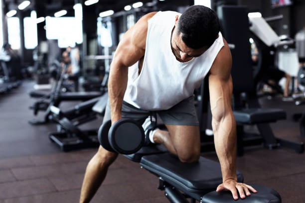 istock Fit and muscular man trains with dumbbells. 1160537437