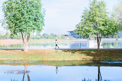 young man runner athlete running  in a park