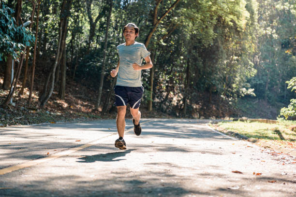 istock Young man runner athlete running on the rode, in park 1160537703