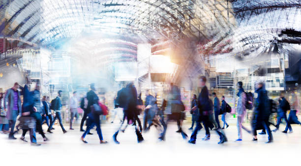 Beautiful motion blur of walking people in train station. Early morning rush hours, busy modern life concept. stock photo