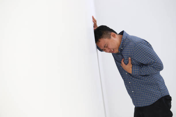 istock Man suffering from chest pain on white background. 1160541793