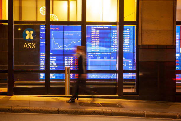 A man in corporate suit walked past ASX (Australian Stock Exchange)