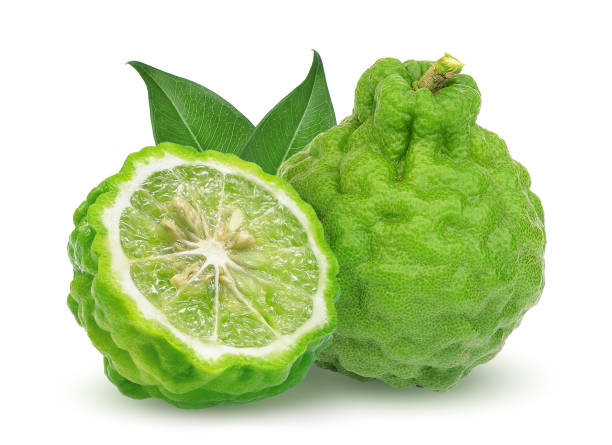 whole and half bergamot fruit with leaf isolated on white background whole and half bergamot fruit with leaf isolated on white background kaffir stock pictures, royalty-free photos & images
