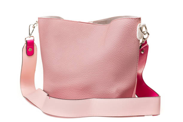 istock leather pink women's bag with a long handle, textured leather, on a white background 1160543835