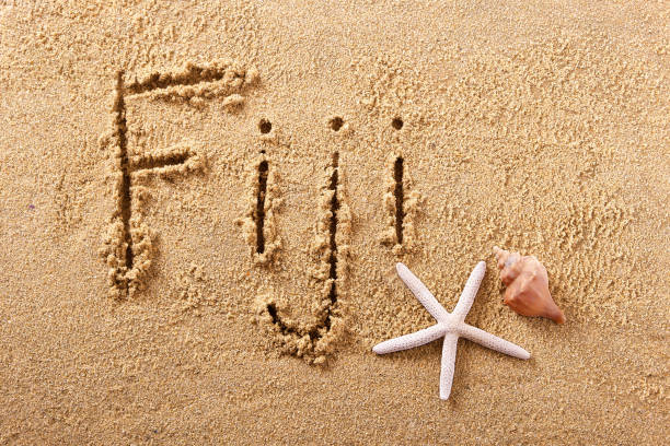 Fiji handwritten beach sand message Fiji hand written beach word travel concept fiji photos stock pictures, royalty-free photos & images