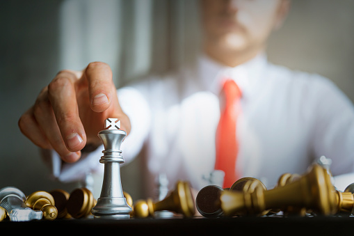 business strategy brainstorm chess board game with hand touch black background with free copy space for your text