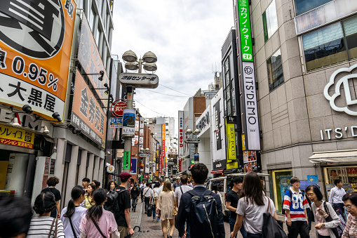 busy crowded shibuya street with various shops and establishments. Shibuya, Tokyo, Japan. Taken on June 28th 2019