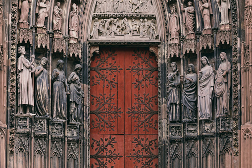The entrance to the grand cathedral in Strasbourg, the main religious landmark of the city. The numerous sculptures adorning the cathedral are clearly visible.