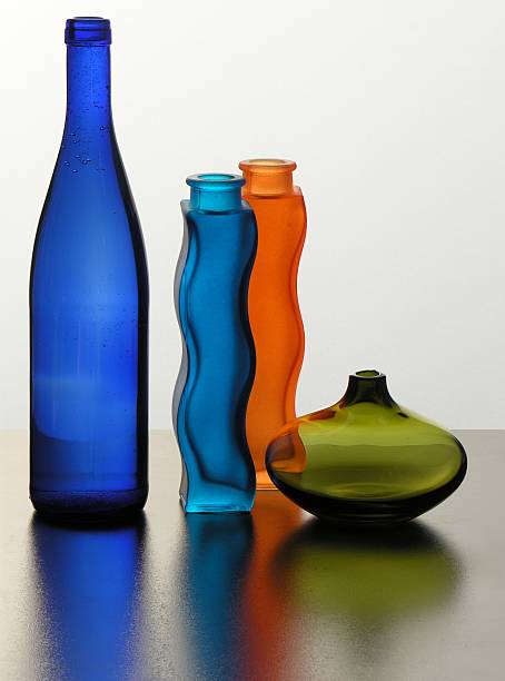 istock coloured bottles and green glass bowl 116055041