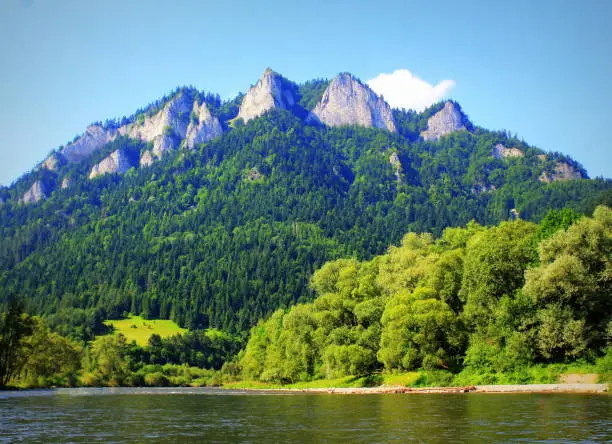 Dunajec river and Three Crowns peak in Pieniny mountains at summer, Poland .