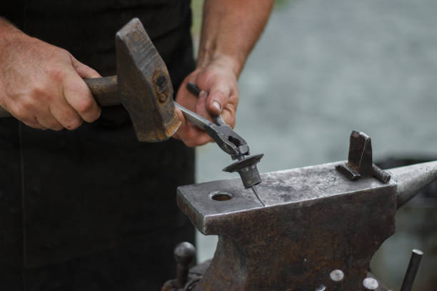istock Route the forge with a hammer and anvil. 1160556954