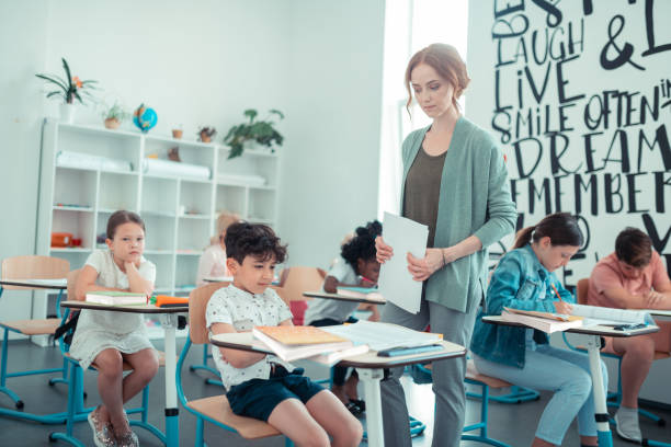 istock Strict teacher looking at upset school boy. 1160558970