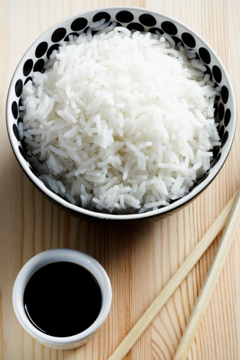 Bowl of basmati rice with spiced soy sauce.