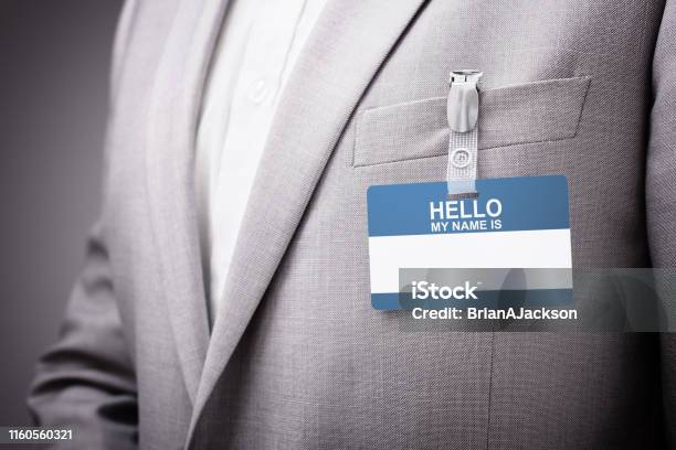 Businessman Wearing Hello My Name Is Tag Stock Photo - Download Image Now - Identity, Greeting, Name Tag