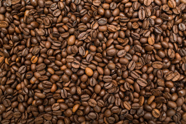 istock Roasted coffee beans brown seeds texture background wallpaper. 1160560483