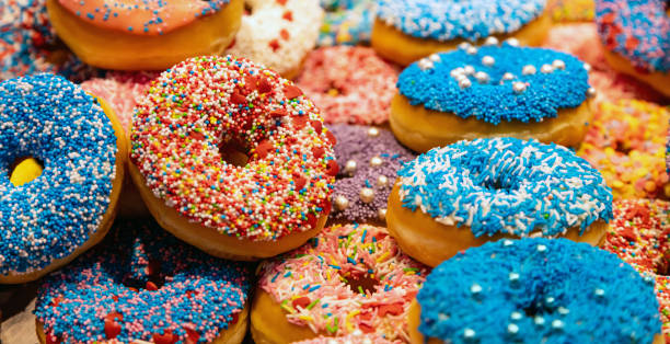 istock Doughnuts with colorful decoration background. Closeup view 1160561290