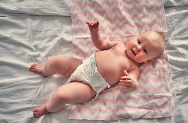 istock Baby girl on bed 1160561447
