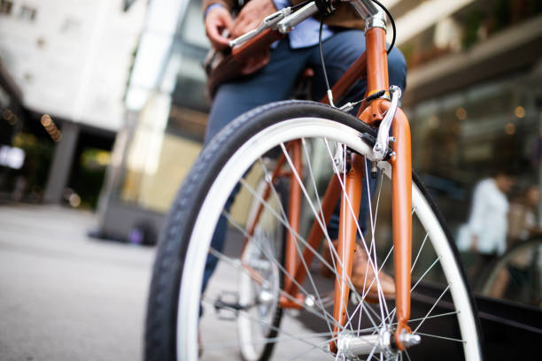 istock Happy businessman riding bicycle to work in morning 1160563062