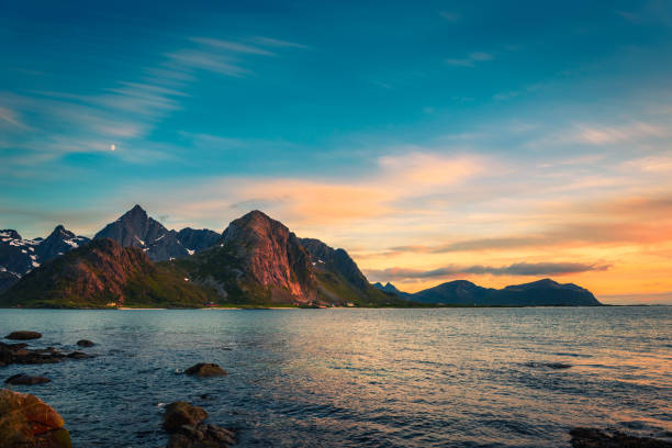 Traveller enjoy summer view of Lofoten Islands in Norway with sunset scenic
