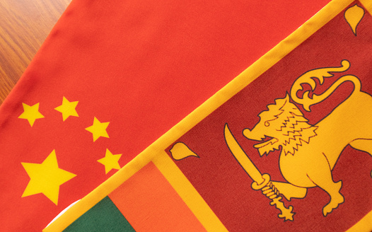 Concept of Bilateral relationship between two countries showing with two flags: China and Sri Lanka.