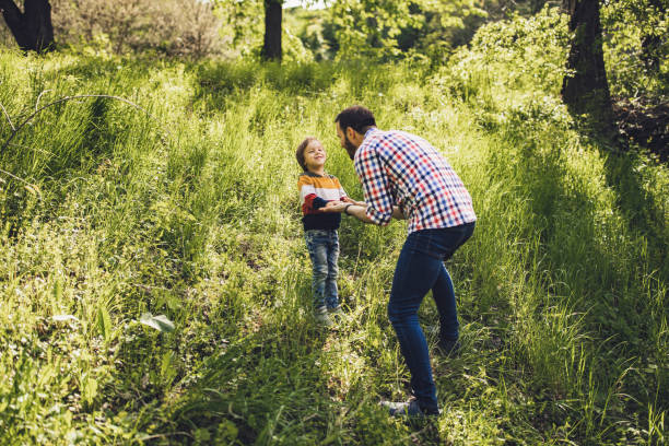 istock Happy single father talking to his small son in the forest. 1160565543
