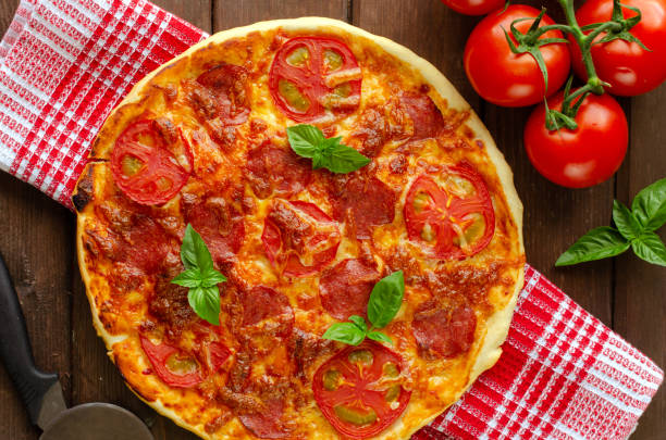 istock Homemade spicy pizza with sausage and tomato. 1160567549