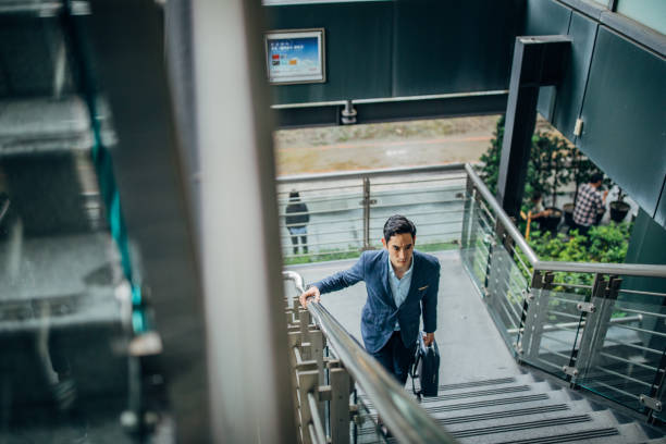 istock Businessman walking up stairway 1160568398