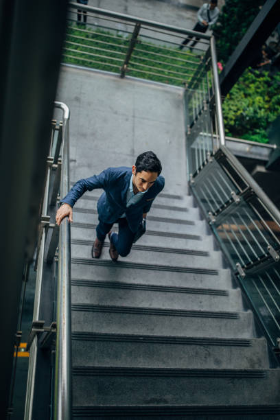 istock Businessman walking up stairway 1160568407