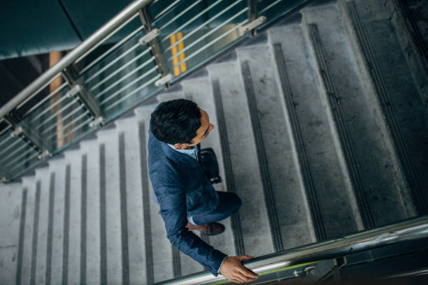 istock Businessman walking up stairway 1160568442