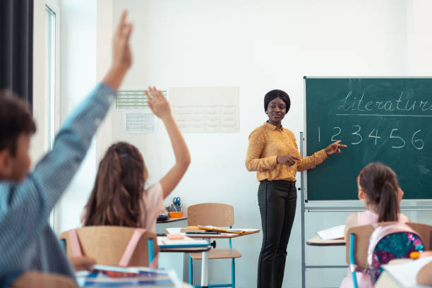 istock Dark-skinned teacher giving the question for her smart pupils 1160569869