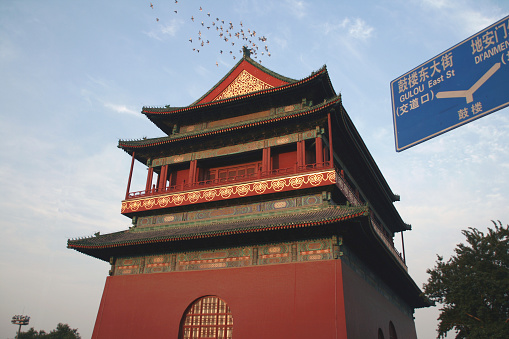 The bell and drum were originally used as musical instruments in China. Afterward, however, they were used for telling time. As early as in the Han Dynasty (206 BC-220), there was 'a morning bell and a dusk drum'. Telling the time by bell and drum played an important role in helping people live and work regularly when there was no other means to keep track of the time. As a result, bell and drum towers became public architectures, and were widely constructed in almost every city throughout the country since the Han Dynasty. In the history of their construction, the bell and drum towers of Beijing are the largest and highest. Their layout is unique, in that they were placed fore-and-aft, not as the traditional sense of standing right-and-left horizontally.