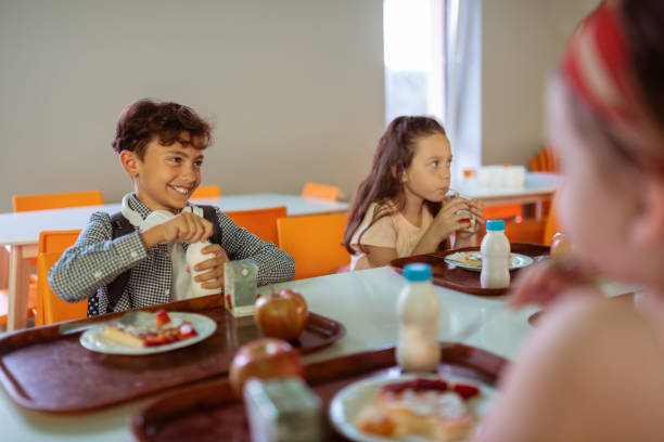 istock Boy opening his bottle of milk while having lunch 1160569910