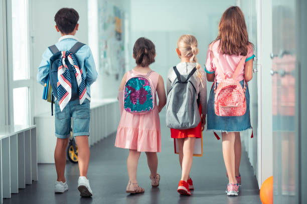 istock Girls and boy wearing nice bright backpacks going to the lesson 1160569982